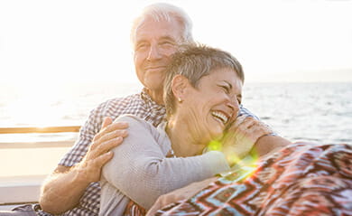 Affectionate couple on a boat trip at sunset